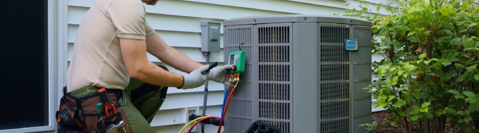 A Blue Peak technician performing tests on an outside AC unit in Tampa