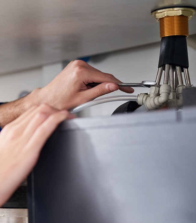 A technician inspecing AC connections